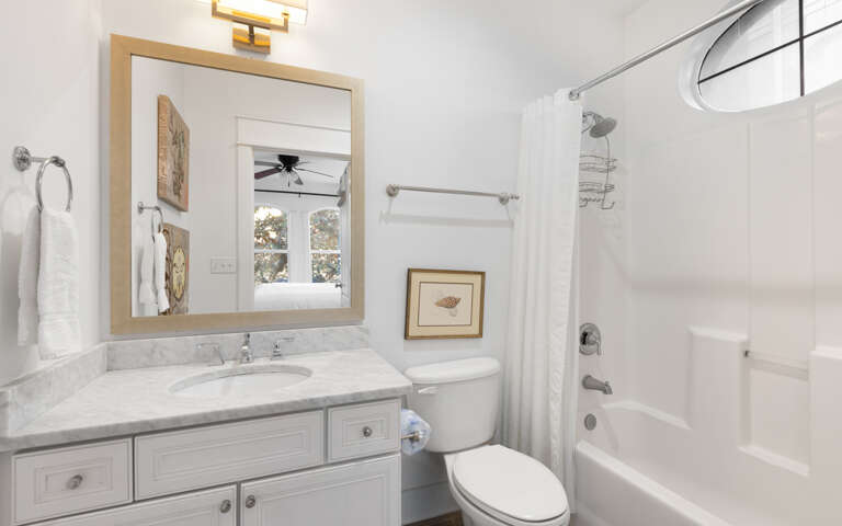 Your pristine bathroom awaits with marble countertops, plush towels, and a relaxing tub-shower combo perfect for unwinding after your adventures.