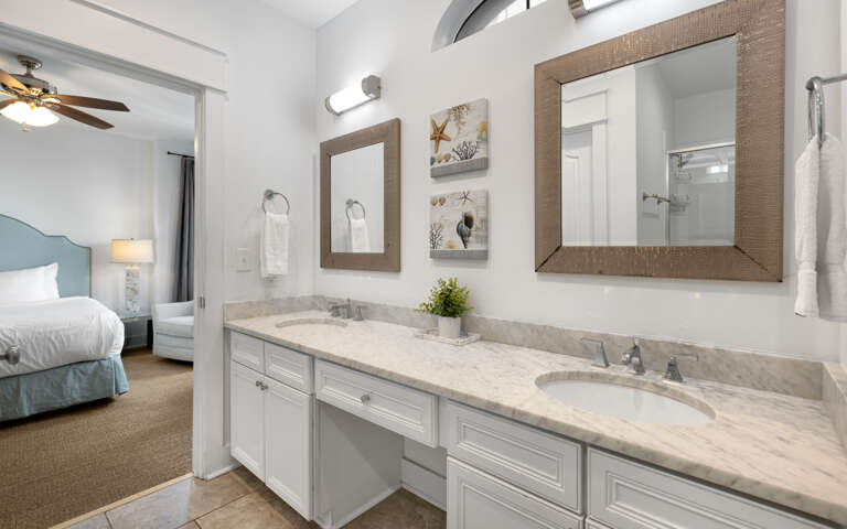 Refresh in your elegant ensuite with dual vanities, marble countertops, and coastal charmâperfectly connected to your peaceful bedroom retreat.