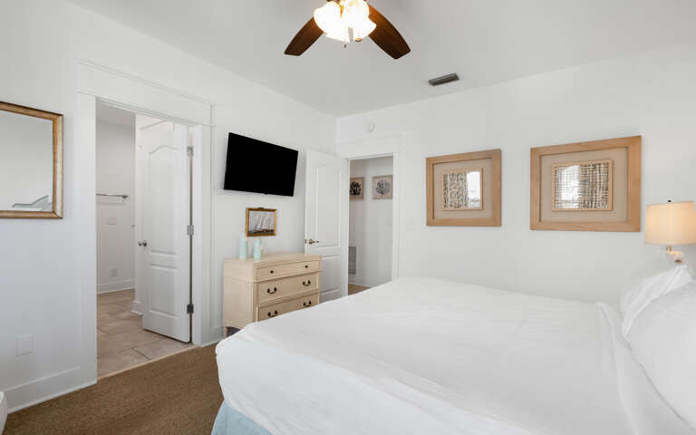 Your serene bedroom sanctuary features crisp white linens, warm coastal touches, and all the comforts you need for restful nights.