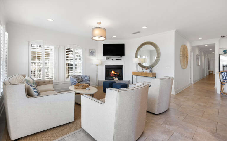 Sink into plush seating around the crackling fireplace while your favorite shows play on the mounted TVâpure comfort awaits.