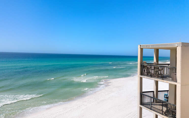 Beachfront property offers stunning Gulf Coast views with pristine white sand beaches and crystal-clear turquoise waters stretching to the horizon.