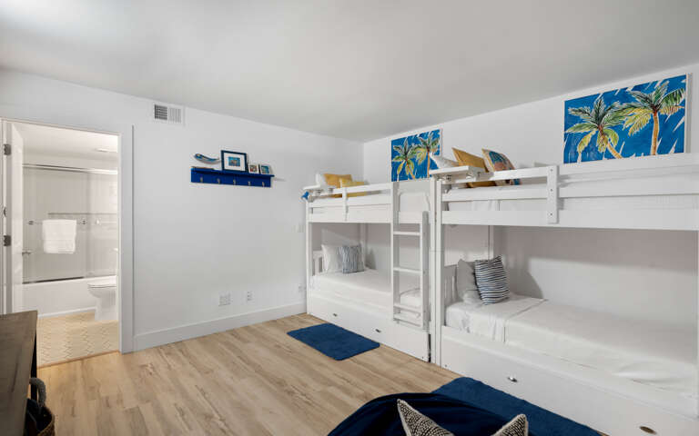 Your group will love this cheerful bunk room with tropical artwork and cozy bedding for four.