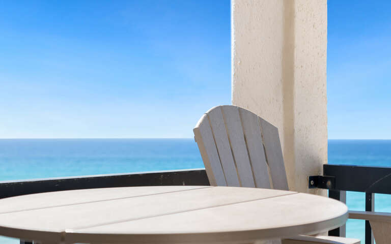 Relax at your private table with stunning gulf views stretching to the horizon from this peaceful balcony retreat.