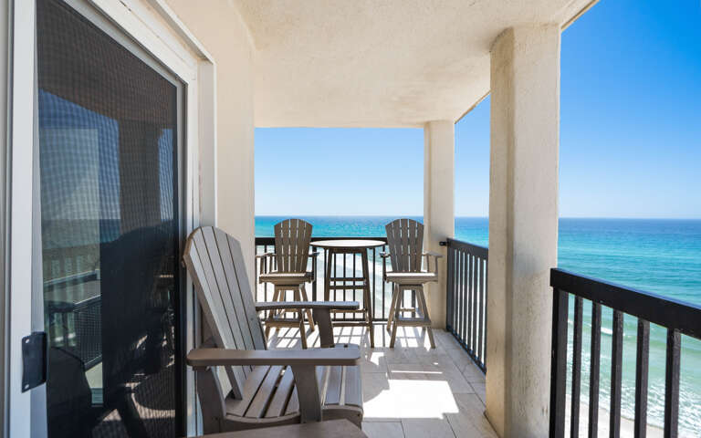 Your private balcony overlooks endless turquoise waters, where Adirondack chairs invite you to sip morning coffee while gulf waves create the perfect soundtrack.