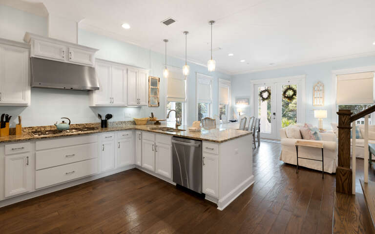 Prepare your favorite meals in this bright, fully-equipped kitchen with granite countertops, stainless appliances, and an island perfect for gathering.
