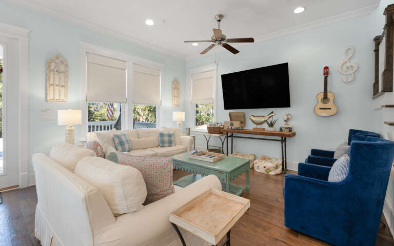 Sink into plush seating while coastal breezes flow through your bright living space, complete with entertainment and charming nautical touches.