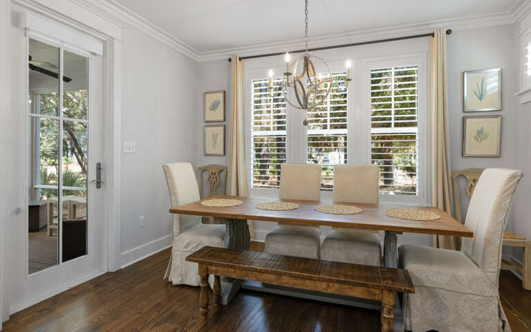 Gather around your elegant dining table where morning coffee and evening conversations flow naturally in this beautifully appointed space.