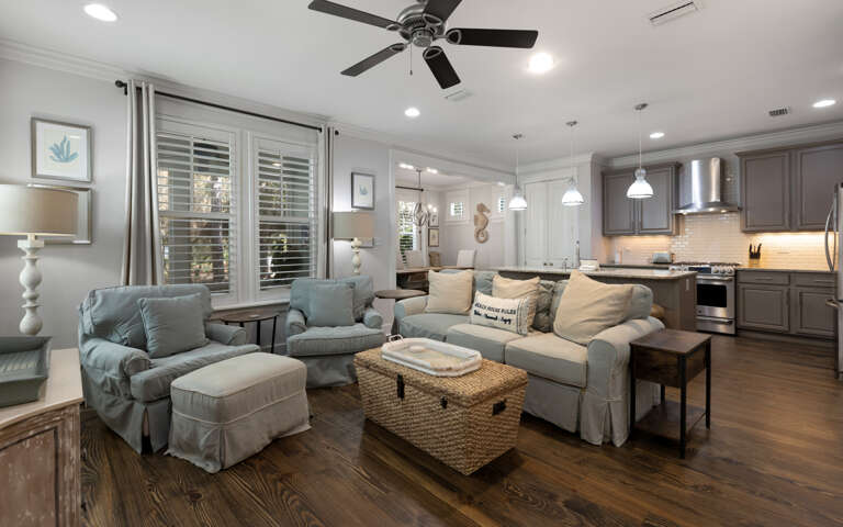 Sink into plush seating in this open-concept space where your living room flows seamlessly into a fully equipped kitchen, perfect for gathering.