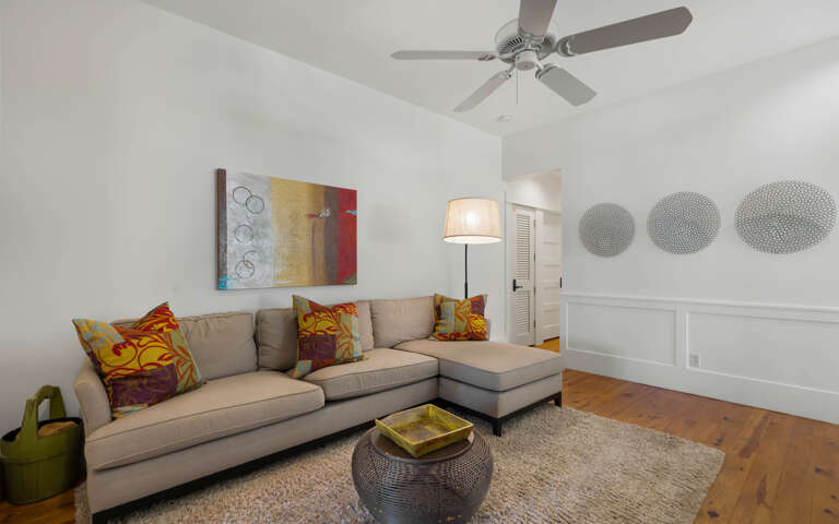 Relax in your stylish living room with cozy sectional seating, vibrant artwork, and thoughtful touches that make it feel like home.