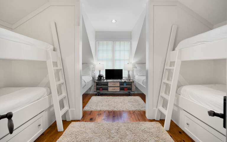 Your group will love this clever bunk room with built-in beds and cozy TV space for movie nights together.
