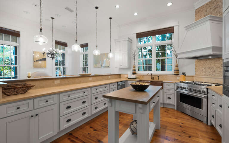 Your spacious kitchen invites culinary adventures with gleaming countertops, modern appliances, and warm natural light streaming through charming windows.