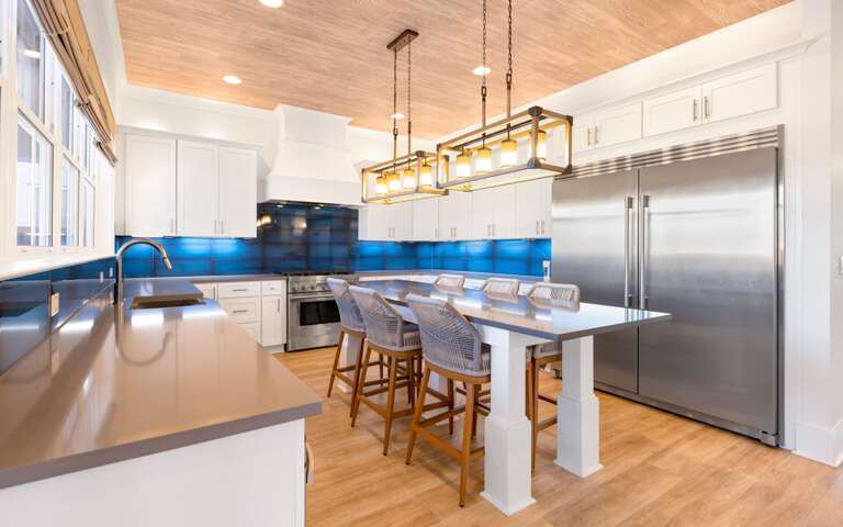 Stylish Kitchen Interior With Island And Stainless Steel Appliances