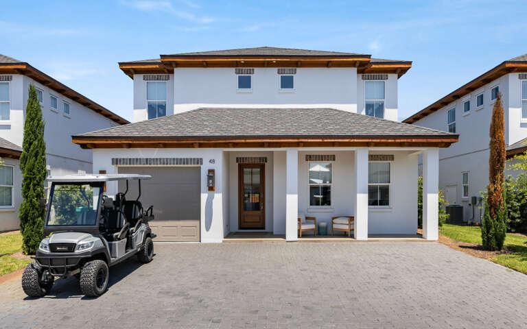 Two-story Residence With Golf Cart Parked Outside
