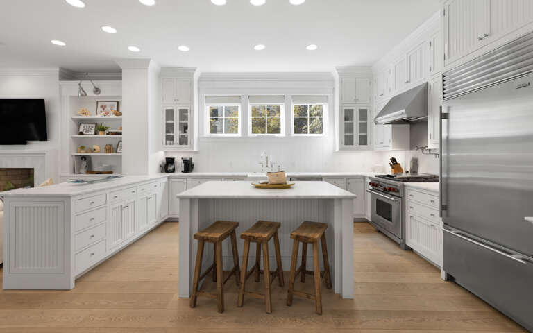 Your bright, fully equipped kitchen invites culinary adventures with stainless steel appliances, spacious island, and warm wood accents creating the perfect gathering spot.