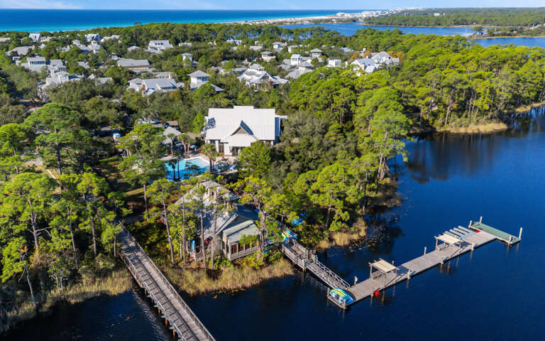 Aerial view captures the prime waterfront location with dock access and expansive lake surroundings.