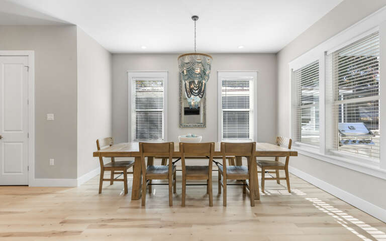 Gather around your spacious dining table where natural light streams through beautiful windows, creating the perfect setting for memorable meals together.