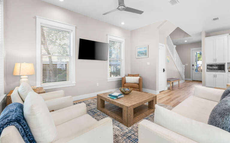 Unwind in your bright, airy living room with plush seating and modern entertainment setup for perfect relaxation.