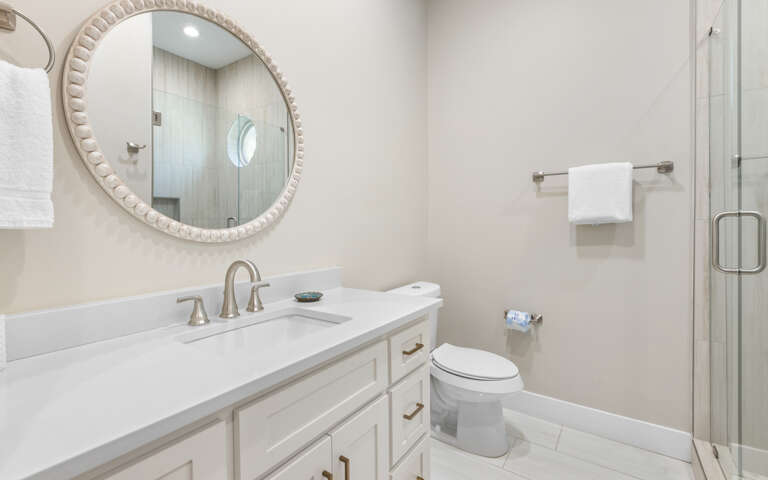 Step into your serene bathroom oasis with marble counters, elegant fixtures, and a luxurious walk-in shower waiting for your arrival.