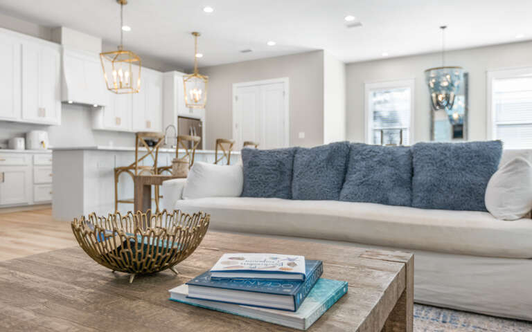 Sink into plush cushions in this bright open living space where kitchen and lounge flow together seamlessly for your perfect gathering spot.