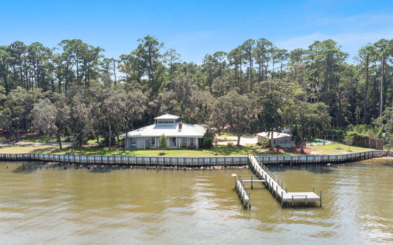 Waterfront House With Dock And Trees