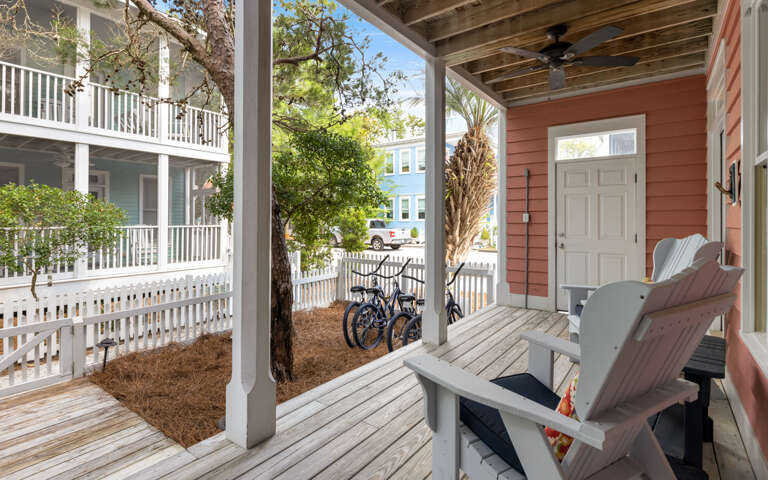 Front Porch With Rocking Chairs And Bicycles At A Vacation Rental