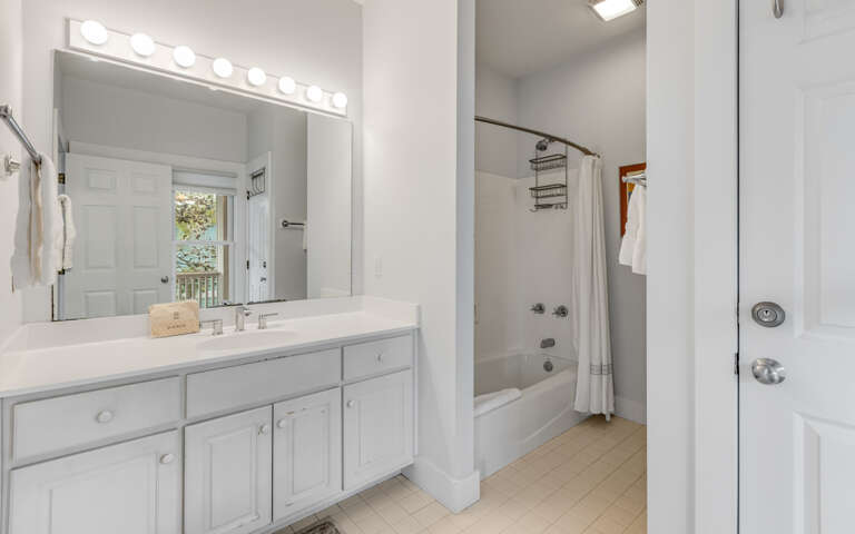 Your bright bathroom features a spacious vanity with Hollywood-style lighting, perfect for getting ready each morning.