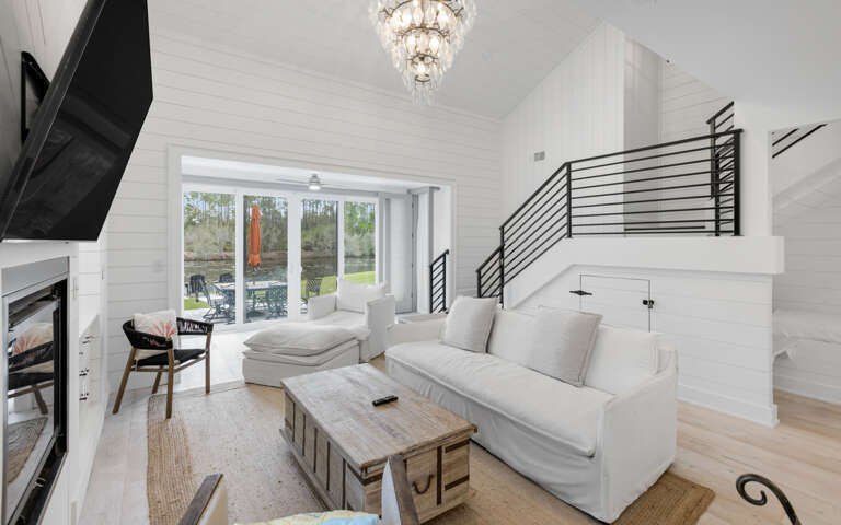 Interior Living Space With Sofa, Table, And Staircase