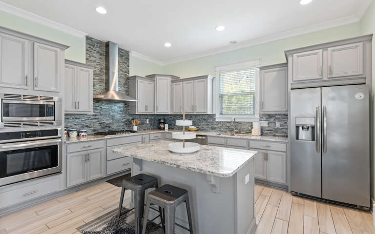 Kitchen Interior With Island And Stainless Steel Appliances