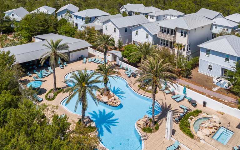 Aerial View Of A Pool Area Surrounded By Houses