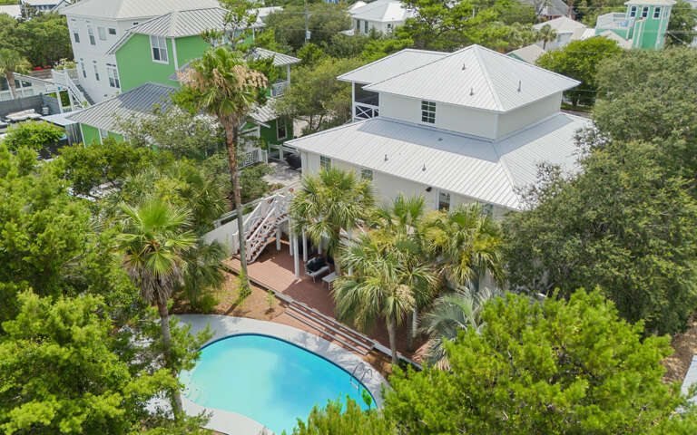 Aerial View Of A Vacation Rental With Pool Surrounded By Trees