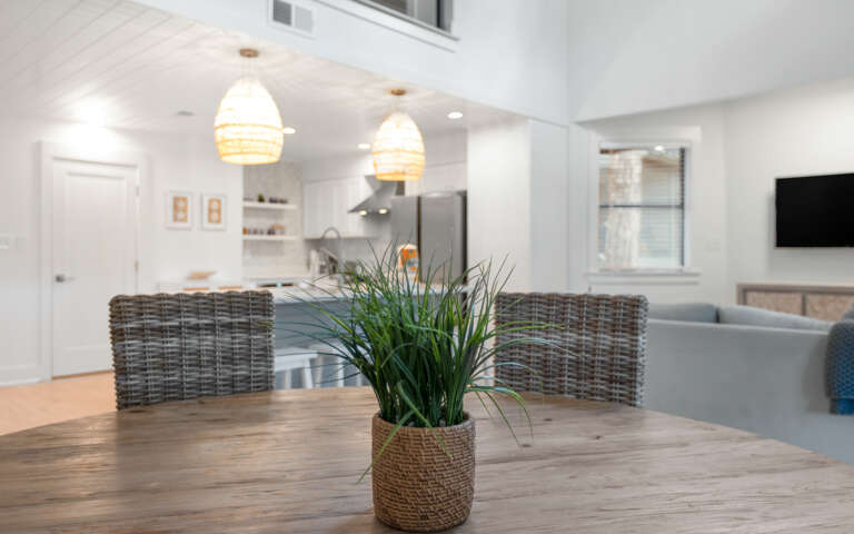Gather around this rustic dining table where morning coffee and evening conversations flow naturally in your bright, open living space.