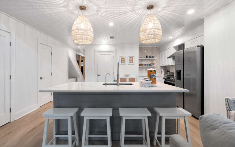 Your stylish kitchen awaits with a spacious island for gathering, modern appliances, and elegant pendant lighting creating the perfect culinary retreat.