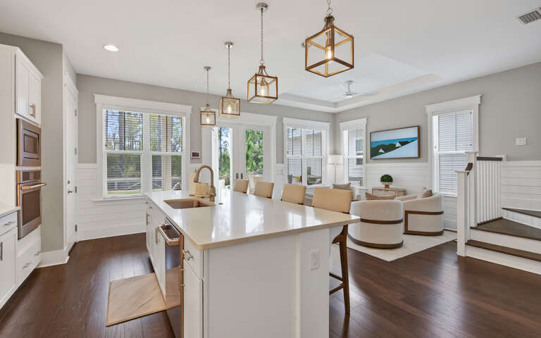 Gather around your stunning kitchen island while warm pendant lights illuminate shared meals and conversations in this open, airy space.