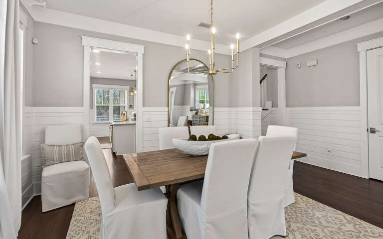 Step into your elegant dining space where warm wood meets crisp white details, perfect for memorable meals together.