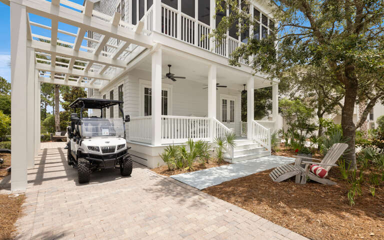 Vacation Rental Viewed Through Vibrant Vegetation, Vehicle Visible