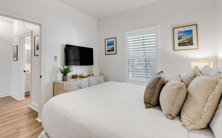 Sink into plush bedding surrounded by coastal artwork and natural textures in your serene retreat.