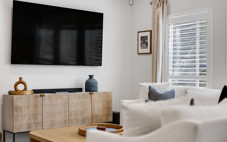 Relax in your bright living room with modern TV, comfy seating, and stylish decor that creates the perfect retreat.