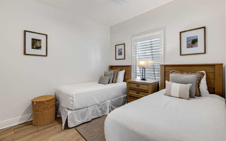 Sink into crisp white linens and rest peacefully in your twin bedroom, where warm wood touches and gentle natural light create the perfect retreat.