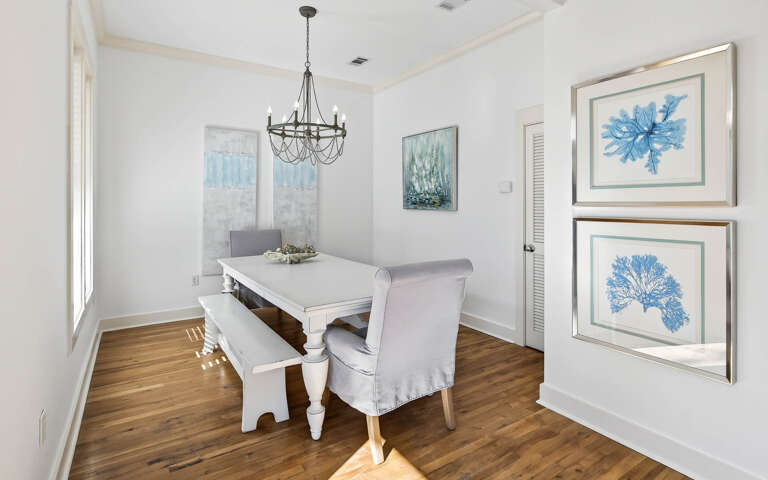 Your elegant dining space features coastal artwork and natural light, perfect for memorable meals with loved ones.