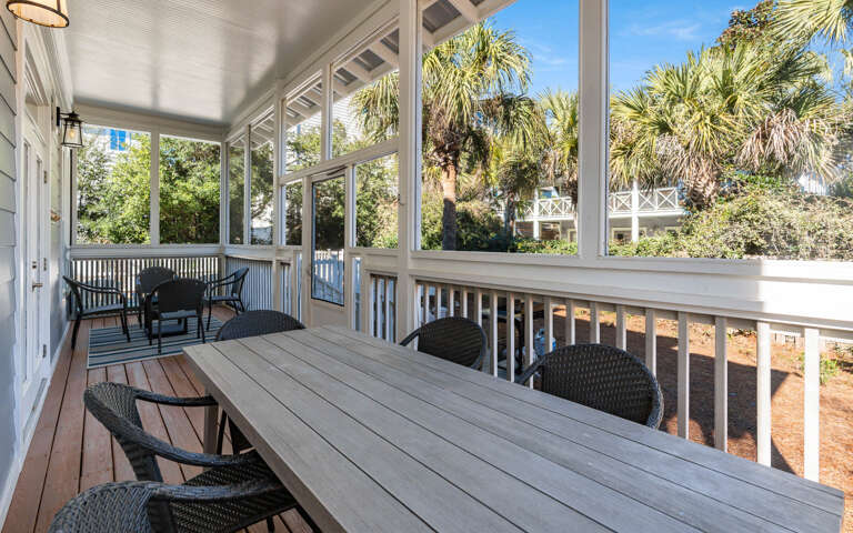 Enjoy your morning coffee on this spacious screened porch where tropical breezes flow through while you dine at the large table.