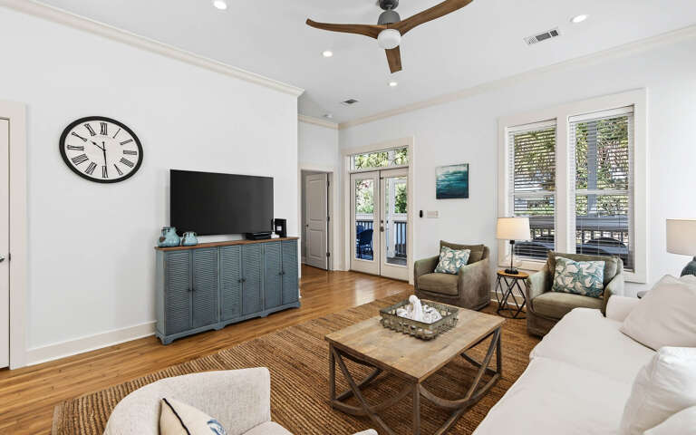 Relax in your bright living room with comfortable seating, large flat-screen TV, and doors opening to your private outdoor space.