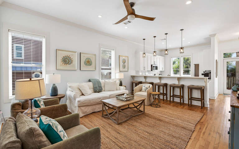 Relax in your spacious open-concept living space with coastal decor, comfortable seating, and a chef's kitchen perfect for vacation meals.