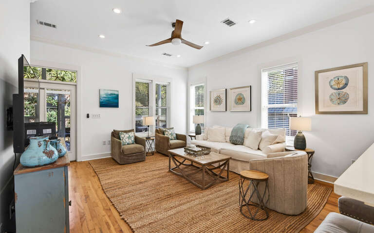 Sink into plush seating in this bright living space where coastal artwork and natural textures create your perfect retreat.