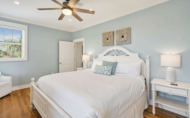 Drift into peaceful dreams in your serene coastal bedroom with soothing blue walls and crisp white linens.