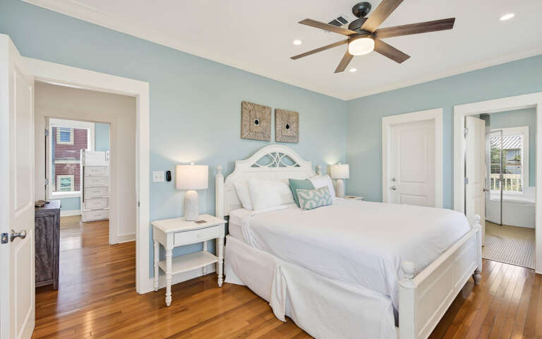 Drift off in your serene coastal retreat, where soft blue walls and crisp white linens create the perfect sanctuary for restful nights.
