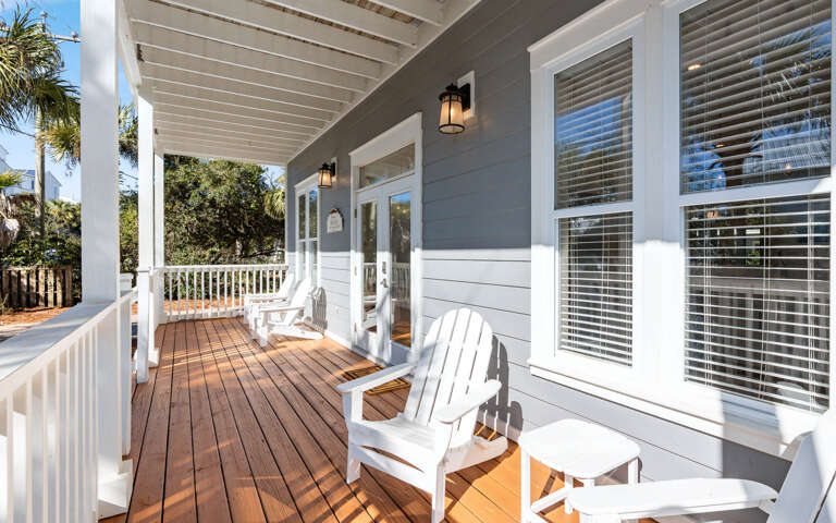 Unwind on your private covered porch with cozy Adirondack chairs, perfect for morning coffee or evening relaxation.