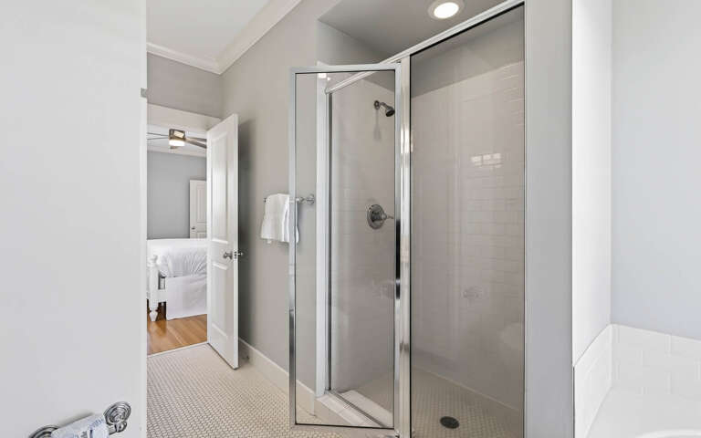 Step into your private spa-like bathroom with a spacious glass shower and soft towels waiting for your arrival.