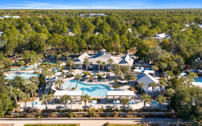 Aerial View Of A Breezy Vacation Rental With Pools, Nestled In Lush Greenery
