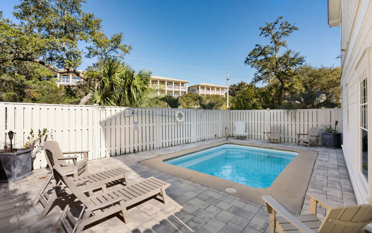 Your private pool sanctuary awaits with comfortable loungers and a peaceful fenced patio perfect for soaking up the sun.