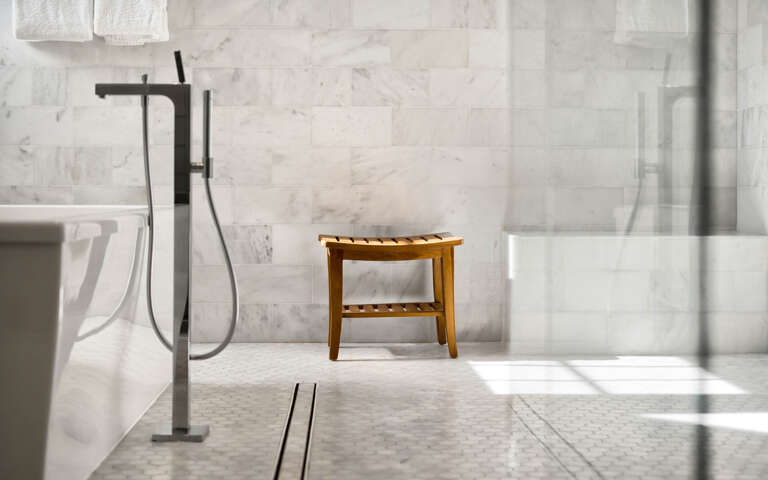 Slip into luxury with your private marble sanctuary, complete with elegant fixtures and warm natural light streaming through.